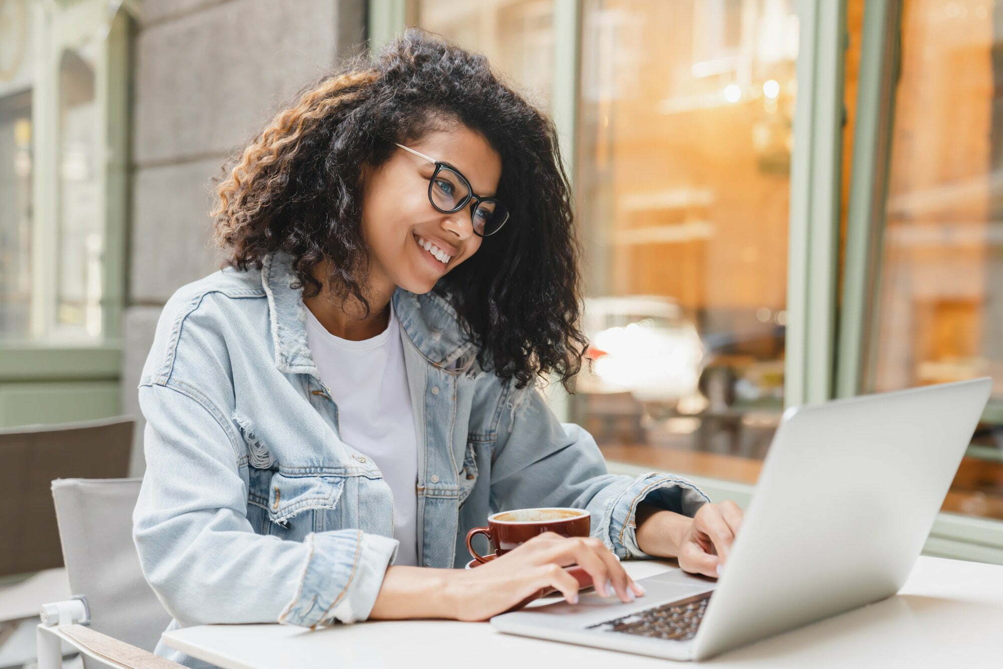 Successful african-american young woman girl student freelancer working remotely online on laptop